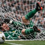 Celtic goalkeeper falling in the back of the net