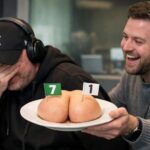 Ewen Cameron in his New York yankees baseball cap getting his bum handed to him on a plate with a 7 flag on one cheek and a 1